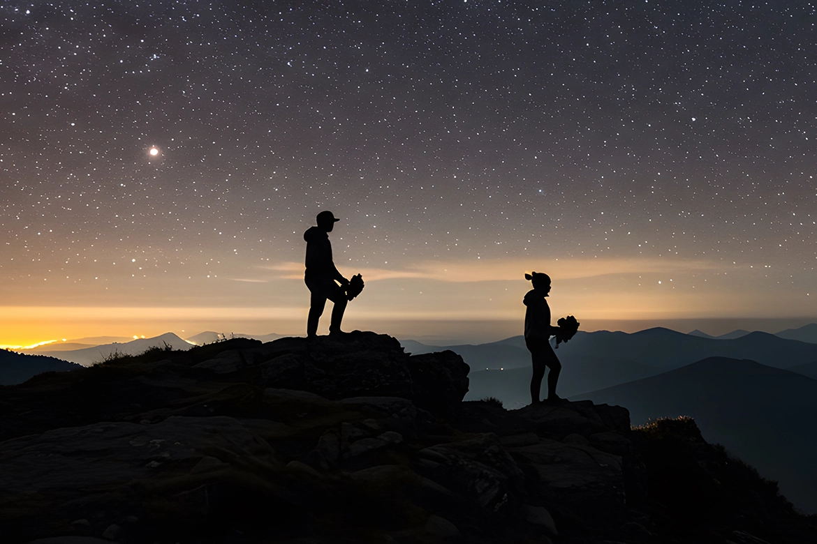 Hiking couple preparing to enjoy stargazing under a clear night sky.