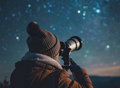 Stargazer viewing the night sky at Bermanzi through a small telescope.