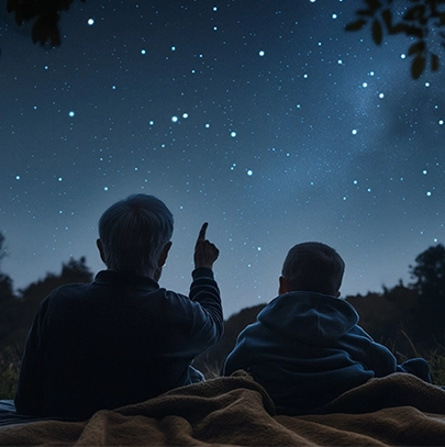 Two boys sitting comfortably beneath a beautiful starlit sky at Bermanzi.